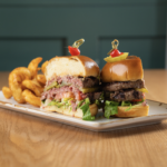 *RASCAL WAGYU BURGER (pink or no-pink) ~ Choice of small arugula salad, jalapeno coleslaw, cup of soup or fries includes: choice of two all-beef patties …or Ultimate Plant Based Burger. No charge for lettuce, tomato, dill pickles or chipotle aioli.